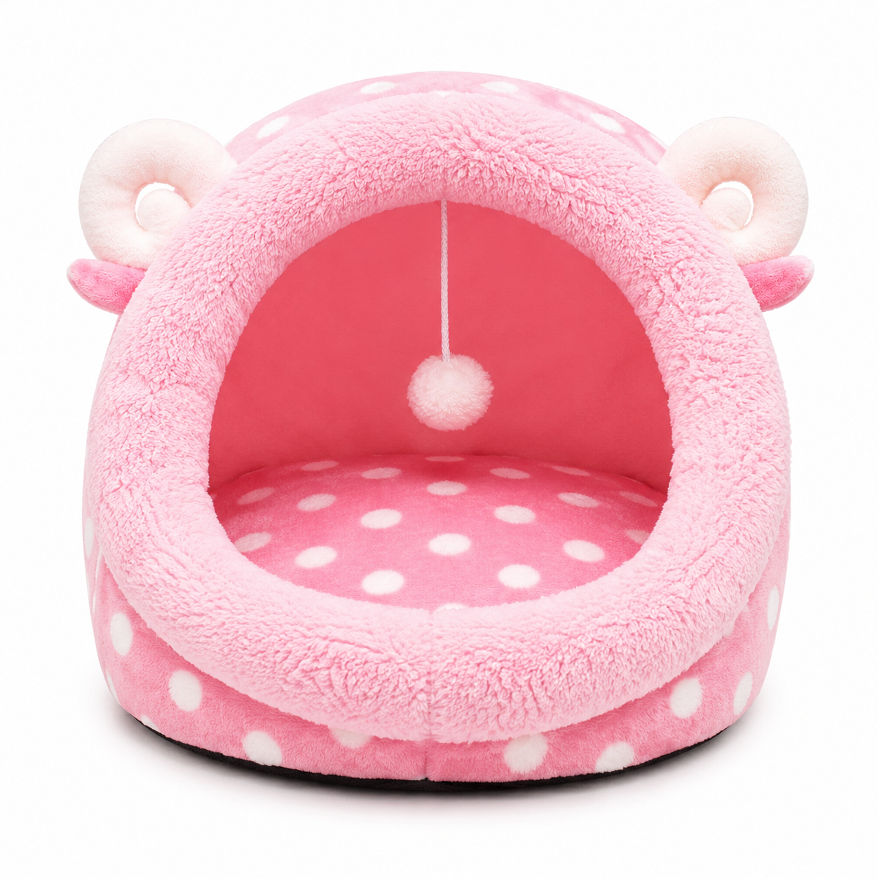 Pink pet bed with white polka dots and a hanging pom-pom on a white background